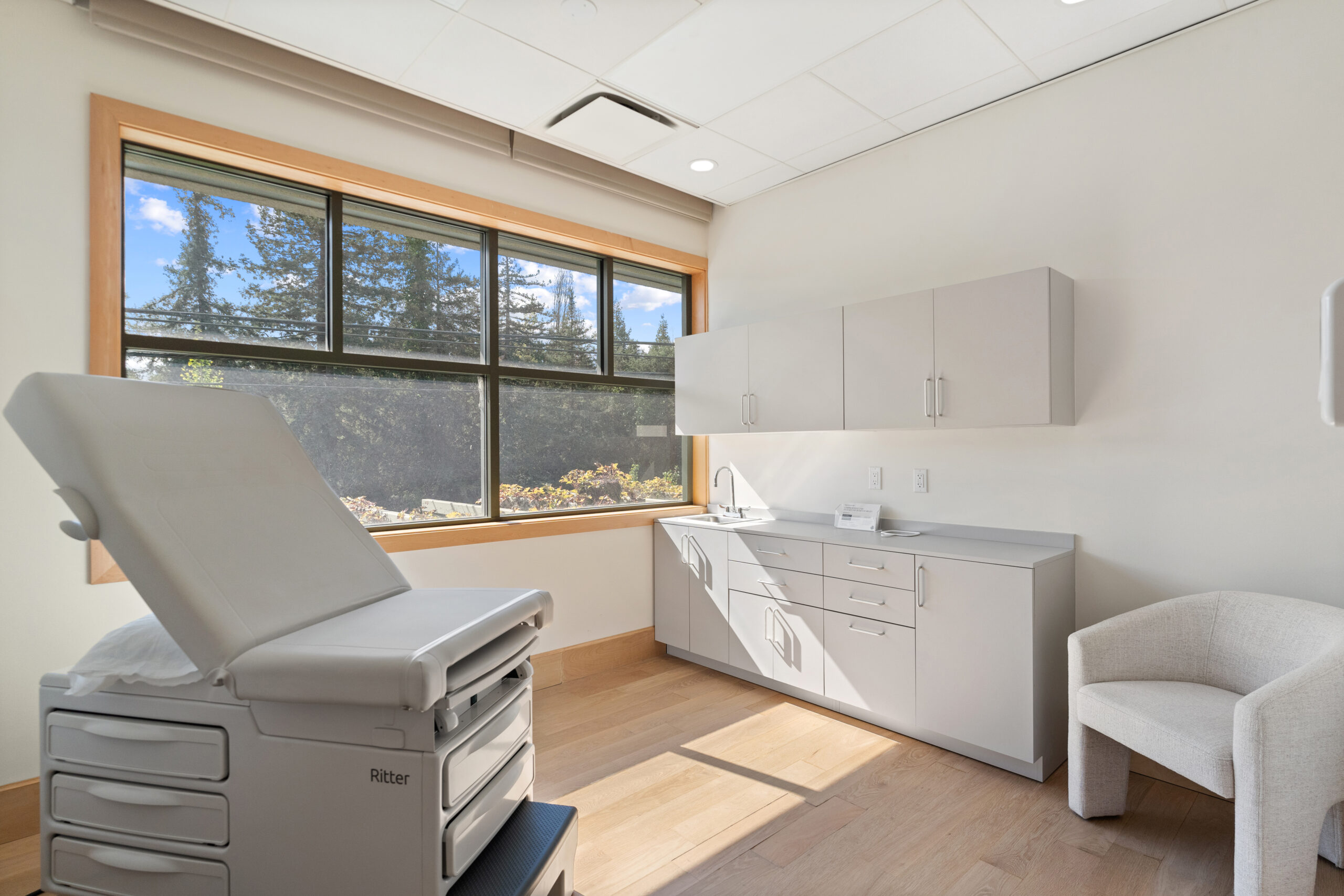 A woman in a white sweater holds a model of the female reproductive system in her cupped hands